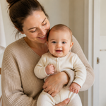 Parent holding a fully clothed baby after bath time in a calm home routine