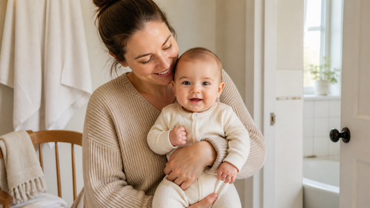 Parent holding a fully clothed baby after bath time in a calm home routine